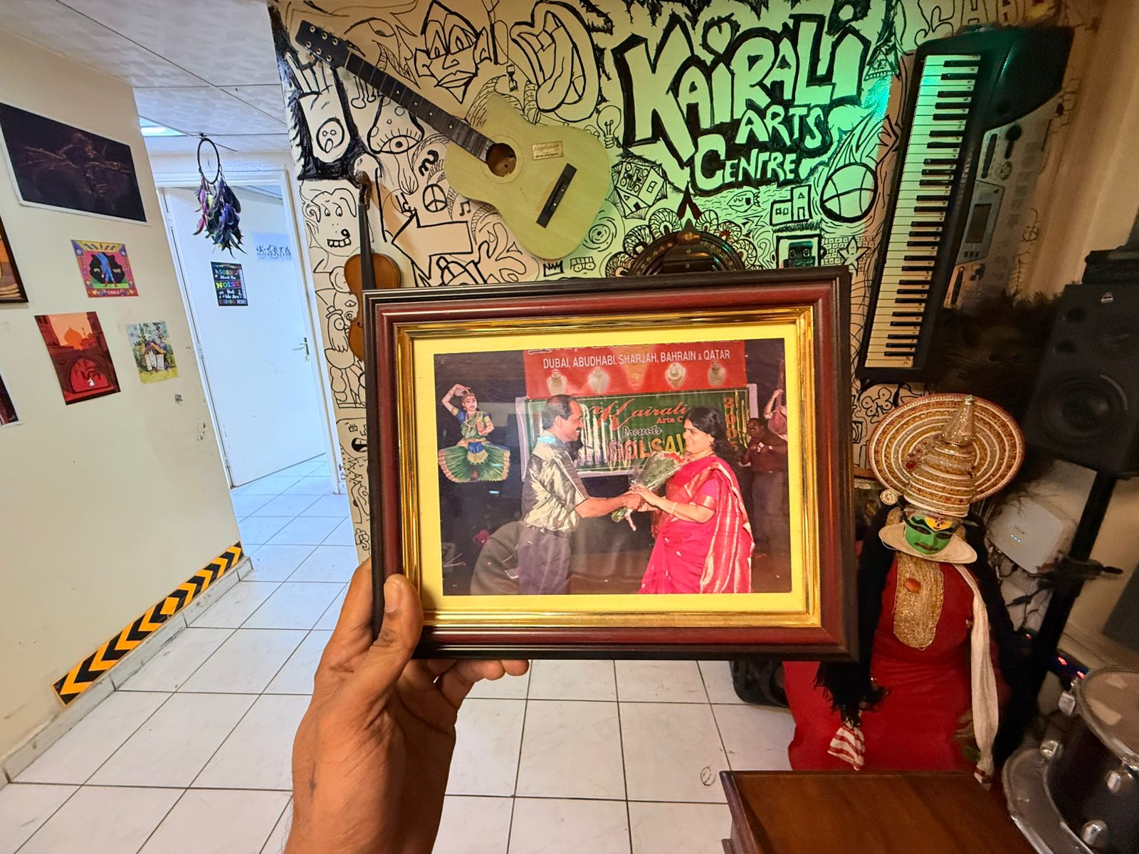 Radhakrishnan presenting Guru Mini Radhakrishnan with a bouquet on the Sargolsavam stage: Kairali Arts Centre's annual cultural production across Dubai, Abu Dhabi, Sharjah, Bahrain and Qatar