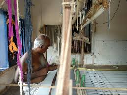 Master weaver at his pit-loom in Koothampally, Kerala