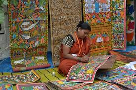Patua woman painter surrounded by her scrolls