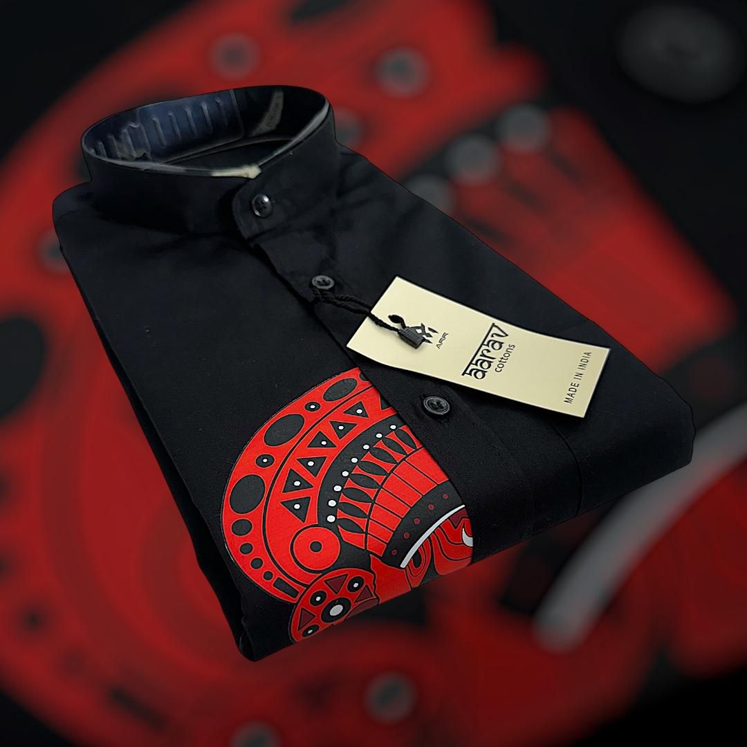 Kairali Koothampally heritage shirt — black with full Theyyam print, paired with white kasavu mundu